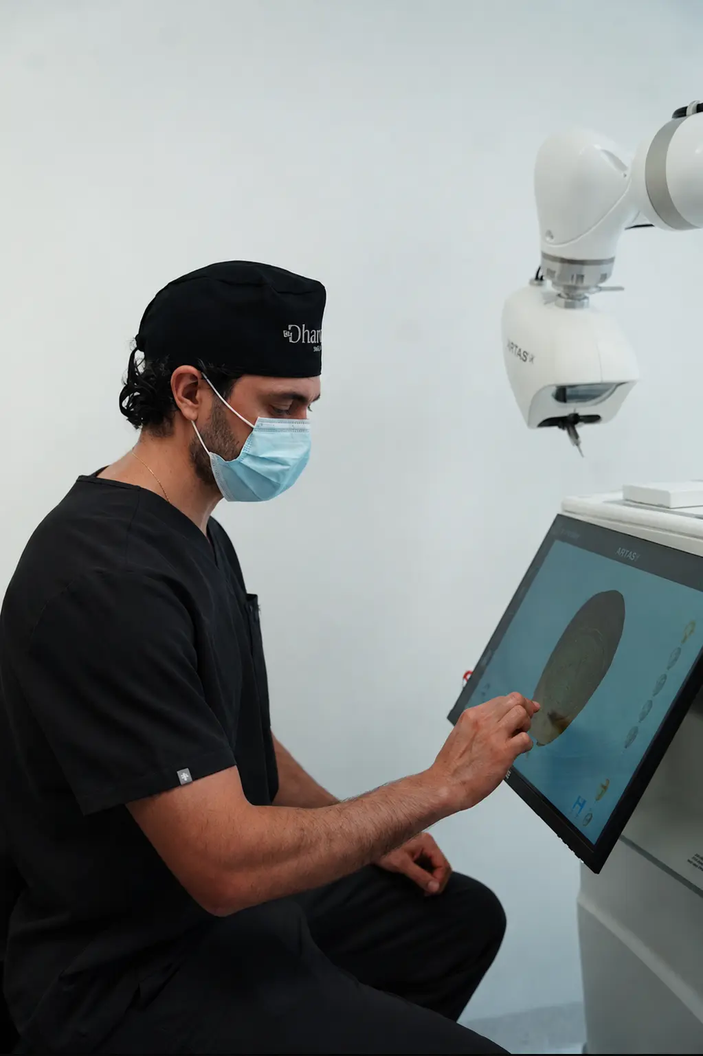 Dharma Hair surgeon planning a robotic hair transplant on the ARTAS iX touchscreen